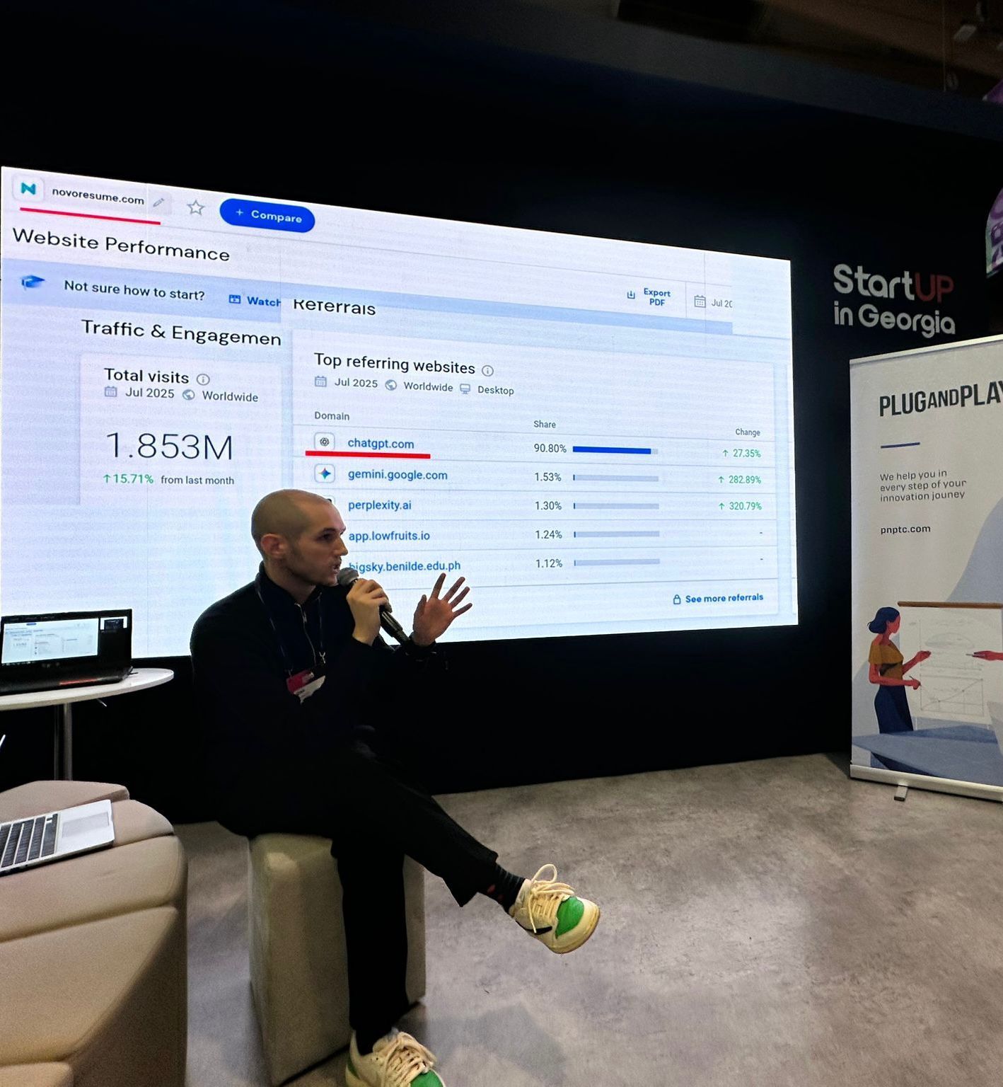Giorgi Muzashvili, AI Visibility Consultant and Co-Founder of Deeprank AI, presenting analytics on stage